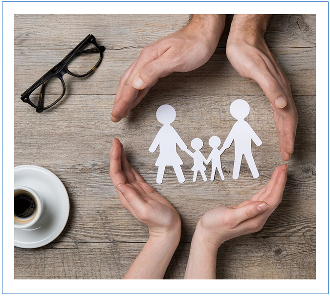 A person 's hands holding paper cut out of family.